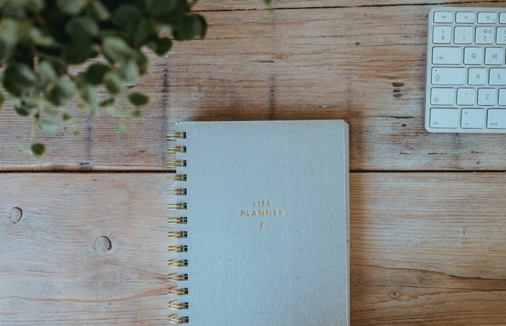 Planner notebook on a wooden desk for a personal money audit