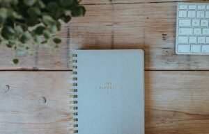 Planner notebook on a wooden desk for a personal money audit
