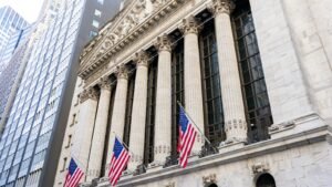 New York Stock Exchange building with American flags on Wall Street