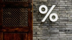 White percentage sign on a brick wall